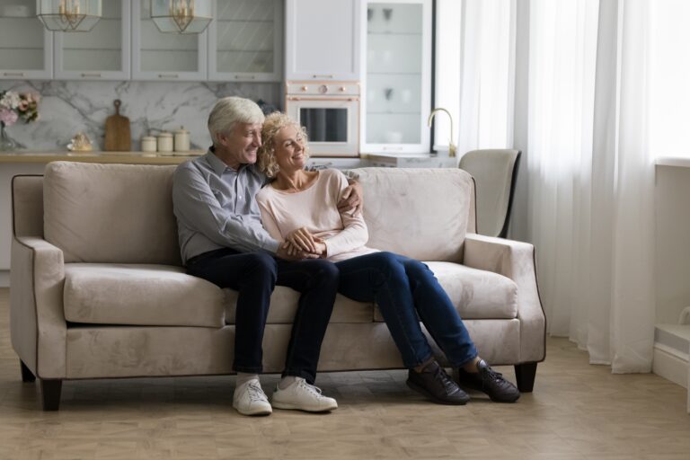 Older couple seated on a couch