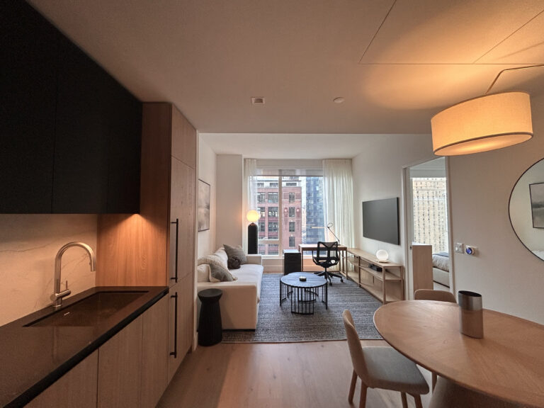 view of clean one-bedroom apartment with open kitchen and living area layout and separate bedroom